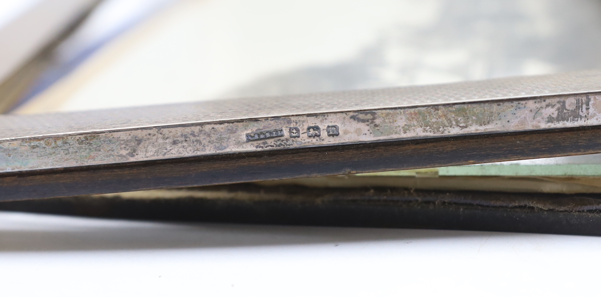 Four assorted early to mid 20th century silver mounted rectangular photograph frames, largest 28.6cm.